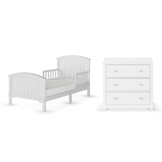 The Child Craft Hampton Toddler Bed in Matte White is low to the ground with one-sided guard rails, featuring a simple, classic design and pairs with a matching matte white three-drawer dresser.
