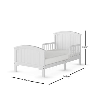 The Child Craft Hampton Toddler Bed in matte white features slatted headboard, footboard, partial guard rails, and a low profile. Dimensions: 142 cm (L) x 78 cm (W) x 76 cm (H). Shown on a plain white background.