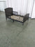 The Child Craft Hampton Toddler Bed in Dapper Gray, featuring slats and raised headboard and footboard, is shown without a crib mattress on a green concrete floor in front of white curtains.