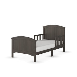 The Child Craft Hampton Toddler Bed in Dapper Gray features a high headboard and footboard, vertical slat panels, and low guard rails. Shown on a white background with a crib mattress.