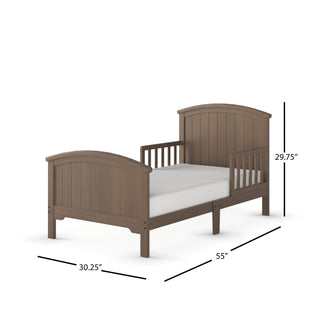 The Child Craft Hampton Toddler Bed in Dusty Heather features an arched headboard and footboard, side rails, and measures 29.75" H x 30.25" W x 55" L. A mattress is shown on the bed.