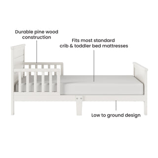 The Child Craft Woodland Toddler Bed in Brushed Cotton has a low-to-the-ground design, sturdy pine wood construction, and safety rails. It fits most standard crib and toddler bed mattresses.