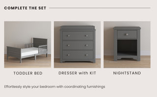 The Child Craft Woodland Toddler Bed in Brushed Pebble, with secure rails, pairs with a matching dresser with changing kit and a nightstand. All are arranged on a light wood floor and the bed fits a standard crib mattress for your child's comfort.