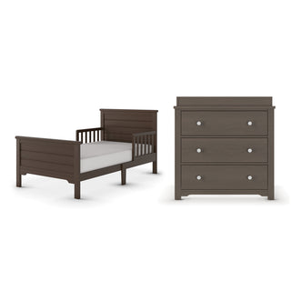 The Child Craft Woodland Toddler Bed in Brushed Truffle, featuring slatted sides, is shown alongside a matching three-drawer dresser with round knobs, both set against a white background.