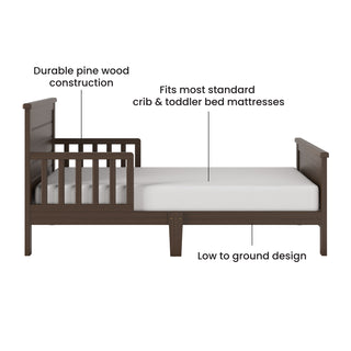 The Child Craft Woodland Toddler Bed in Brushed Truffle features durable pine wood, side rails, a low-to-the-ground design, and fits most standard crib & toddler bed mattresses.