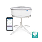 The HALO BassiNest® Connected Swivel Sleeper 3.0, a modern white smart bassinet with light gray lining on a tripod stand, features AutoSoothe tech, Baby Safety Verified badge, and connects to a baby monitoring app via smartphone.
