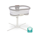A HALO BassiNest® Luxe Swivel Sleeper Bassinet in gray and white with mesh sides and a white swivel base is shown beside a Baby Safety Alliance Verified badge.