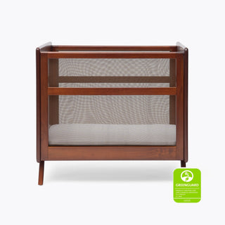 The HALO Mini Breathable Mesh Crib features breathable mesh sides and a light mattress on a white background. A green GREENGUARD Gold certification badge appears in the lower right corner.