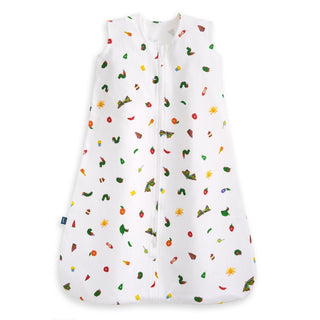 The HALO Eric Carle The Hungry Caterpillar 100% Cotton Wearable Blanket TOG 0.5 is a white sleep sack with a front zipper and colorful food, sun, and caterpillar prints inspired by The Very Hungry Caterpillar book.