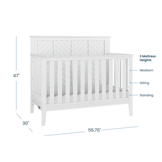 The Child Craft Atwood 2-Piece Crib and DreamWeave Set in Matte White features slatted sides, a chevron-patterned back, 3 mattress heights, and fits the HALO DreamWeave mattress. Measures 47"H x 55.75"W x 30"D.