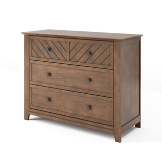The Child Craft Atwood 3-Drawer Dresser in Cocoa Bean features a chevron-patterned top drawer, two plain lower drawers with round black knobs, and a warm brown finish—ideal for use with a changing table topper.