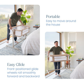 A man moves the HALO 2-in-1 Bedside Bassinet Sleeper beside a bed in a bright bedroom. The bassinet’s wheels and smooth gliding feature highlight its portability for easy bedside use.
