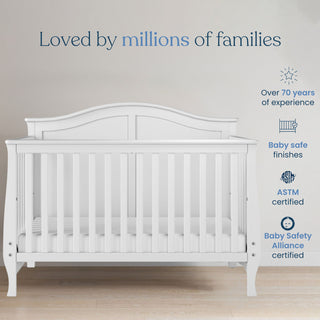 The Child Craft Camden 2-Piece Crib and DreamWeave Set in Matte White stands on a wooden floor against a light wall. With 70+ years’ experience, it features baby-safe finishes, is ASTM and Baby Safety Alliance certified, and fits a breathable crib mattress.