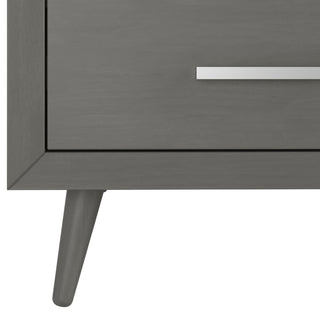 Close-up of the Child Craft Cranbrook 4 Drawer Chest in Lunar Gray, showcasing a tapered leg and horizontal silver drawer handle. This modern, minimalist piece is perfect as nursery furniture or a mid-century modern dresser.