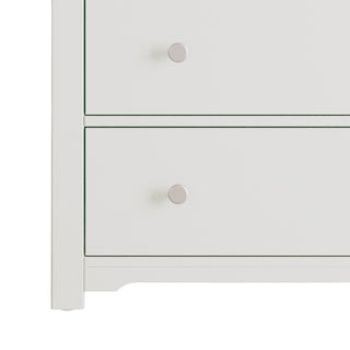 Close-up of the left side of the Child Craft Harmony 3-Drawer Dresser with Changing Table Topper in Brushed Cotton, showing two drawers with round silver knobs. Part of this nursery furniture appears against a plain background.