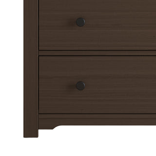 Close-up of the lower left corner of the Child Craft Harmony 3-Drawer Dresser with Changing Table Topper in Brushed Truffle, showing two drawers with round black knobs—ideal for nursery storage or use as a changing table.