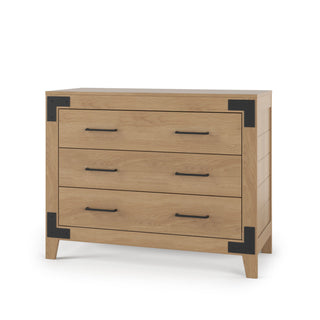 The Child Craft Lucas Dresser in Nutmeg features three drawers, black metal handles, and corner accents. With a sturdy build and modern farmhouse style, this dresser stands on four short legs for a fresh look in any nursery.
