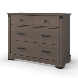 The Child Craft Redmond 3 Drawer Dresser in Dapper Gray features two small drawers with round black knobs and a large lower drawer with a bar handle, all on short feet—ideal for keeping your nursery organized.