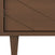 Close-up of the Surrey Hill 5 Drawer Chest by Child Craft in Toasted Chestnut, showing the textured wood corner with angled grooves, a diamond-patterned drawer front, and tapered leg for a modern geometric look.