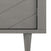 Close-up of the Child Craft Surrey Hill 5 Drawer Chest in Lunar Gray, highlighting its diagonal groove design and single tapered leg, with part of the door’s edge and hinge visible.