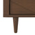 Close-up of the bottom corner of the Child Craft Surrey Hill 3 Drawer Dresser in Toasted Chestnut, showing its tapered leg and diagonal groove detail on the drawer front with a smooth, medium brown finish.