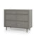 The Child Craft Surrey Hill 3 Drawer Dresser in Lunar Gray features angled legs and subtle geometric front panels, offering a modern, chic storage solution for your nursery.