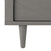 Close-up of the bottom left corner of the Child Craft Surrey Hill 3 Drawer Dresser in Lunar Gray, showing a leg and diagonal front panel design—ideal for modern nurseries.