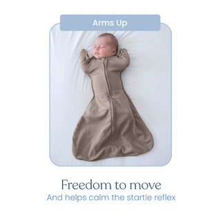 A baby sleeps on their back with arms up, wearing the beige HALO SwaddleStretch™ Newborn Swaddle TOG 0.5. Text above reads Arms Up; below: Freedom to move and helps calm the startle reflex.