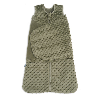 The HALO Swaddle Plushy Dot Velboa TOG 3.0 is an olive green sleep sack with soft, textured fabric, a raised dot pattern, front zipper, and adjustable swaddle wings for comfort.