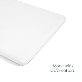 A white rectangular HALO Mini Crib Sheet, 100% cotton, with "Made with 100% cotton" in blue on a white background; fits the HALO Breathable Mesh Mini Crib. Comes as a 2-pack.