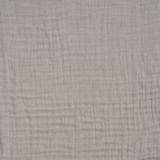 A close-up of the HALO BassiNest® Fitted Sheet 100% Organic Cotton Muslin 2-Pack shows light gray, textured muslin with a subtle crisscross pattern and visible threads—ideal for breathable crib sheets.