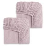 Two mauve-colored HALO Fitted Crib Sheets, 100% Organic Cotton Muslin (2 Pack), are folded with elastic edges visible on a white background. The soft, textured fabric suggests comfort and a gently crinkled appearance.