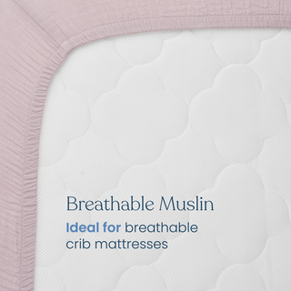 Close-up of the HALO Fitted Crib Sheets 100% Organic Cotton Muslin 2 Pack in mauve on a white crib mattress. Text on the mattress reads: “Breathable Muslin. Ideal for breathable crib mattresses.”.