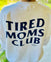 The HALO Tired Moms Club Sweatshirt features bold black TIRED MOMS CLUB text on the back—a cozy, community-inspired piece for moms embracing motherhood.