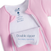 A close-up of Baby Merlin's Magic Sleepsuit® 100% Cotton by HALO in pink with white lining, featuring a double zipper and an easy-open flap—a cozy, convenient sleepwear choice for babies.