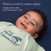 A smiling baby lies on a dark blue surface, wearing the HALO Baby Merlin's Magic Sleepsuit® 100% Cotton with a wizard hat logo. White text above reads: Where comfort meets safety. The perfect swaddle transition for safe back sleeping in crib.