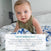 A baby with light hair and blue eyes, dressed in green, sits on a bed covered with the aden + anais boutique silky soft muslin dream blanket. A positive review about this breathable blanket appears at the bottom of the image.