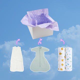 A white gift box filled with tissue paper sits above an aden + anais Swaddle Box Bundle, featuring a wearable blanket and two rolled muslin blankets, with arrows pointing from the items toward the box against a blue sky.