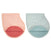Two organic cotton muslin burpy bibs by aden + anais are shown: the left is pink with a red underside, and the right is light blue with a turquoise underside. Their GOTS-certified, curved layered design ensures a soft texture for babies.