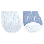 The aden + anais organic cotton muslin burpy bibs 2 pack includes two GOTS certified cloths: one with a light blue whale pattern and the other in darker blue with white whales and stars, featuring a curved seam and quilted lining for comfort and style.