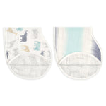 The aden + anais boutique silky soft burpy bib 2 pack includes two curved cloths: one with muted elephant patterns and another with a blue-gray gradient. These bibs are extra absorbent, featuring textured light gray half-circle sections at the bottom.
