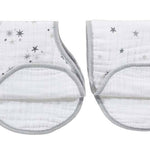 The image shows two aden + anais burpy bibs from the boutique 100% cotton muslin 2-pack: white with gray star patterns, featuring a patented design, absorbent muslin fabric, a rounded shape, and gray edging.