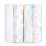 Four organic cotton muslin swaddle blanket rolls by aden + anais are lined up vertically, featuring GOTS certified sustainable designs of pastel stars, colorful hot air balloons, watercolor clouds, and muted-tone balloons.