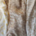 Three swatches from the aden + anais boutique silky soft swaddle blanket 3 pack: left is bamboo viscose with yellow leaves on white; center has white floral designs on beige; right features a brown tree and floral design.