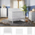 A nursery featuring the Child Craft Atwood 3-Piece Nursery Set—white convertible crib, dresser, and chest—rests on a gray rug. Toys, plants, and decor accent blue and gray star-patterned walls, with natural light streaming through a window.