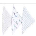 Three aden + anais boutique 100% cotton muslin oversized washcloths hang on a rod: the left with a gray grid, the middle with blue and green animal prints, and the right with blue and white stripes. These layers are soft and absorbent for delicate skin.