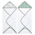 The aden + anais essentials cotton muslin hooded towels 2-pack features two white towels with green trim, crafted from plush cotton terry. One has a wildlife pattern on the hood, the other has stylized arrows, both super absorbent with hanging loops for convenience.