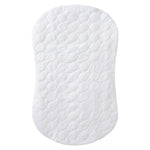 The HALO BassiNest® Protective Cover is an oval, white quilted mattress pad with a subtle circular pattern. Soft and cushioned, it features a waterproof barrier and is custom-designed to fit contoured bassinet or crib mattresses.