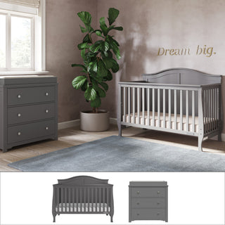 A modern nursery with the Child Craft Camden 2-Piece Nursery Set—crib and dresser—plus a potted plant and blue rug. "Dream big." is written above the crib as natural light streams through a window on the left.
