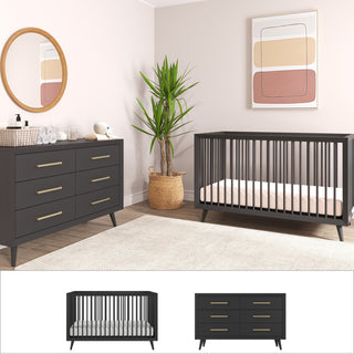 A modern nursery styled with Child Craft’s Cranbrook 2-Piece Nursery Set: a dark gray convertible crib and matching 6-drawer dresser with gold handles, plus Mid-Century Modern décor, a large plant, round mirror, abstract art, plush toy, and neutral hues.